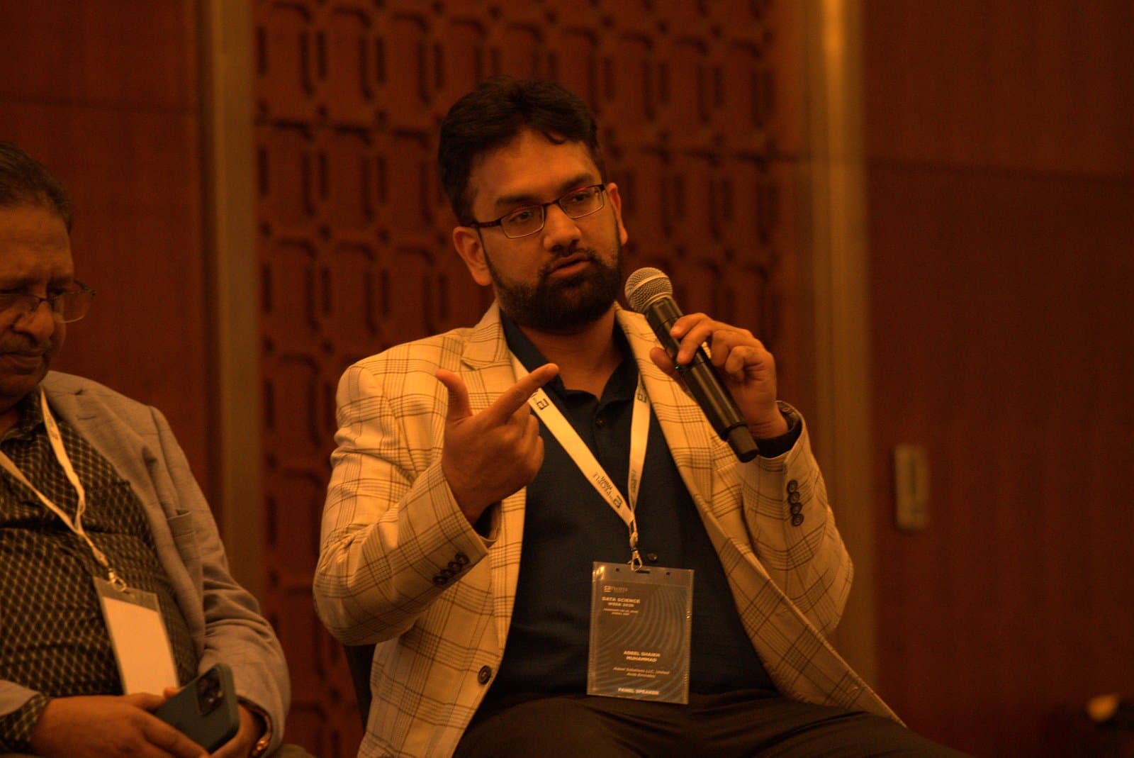 Speaking on panel with mic